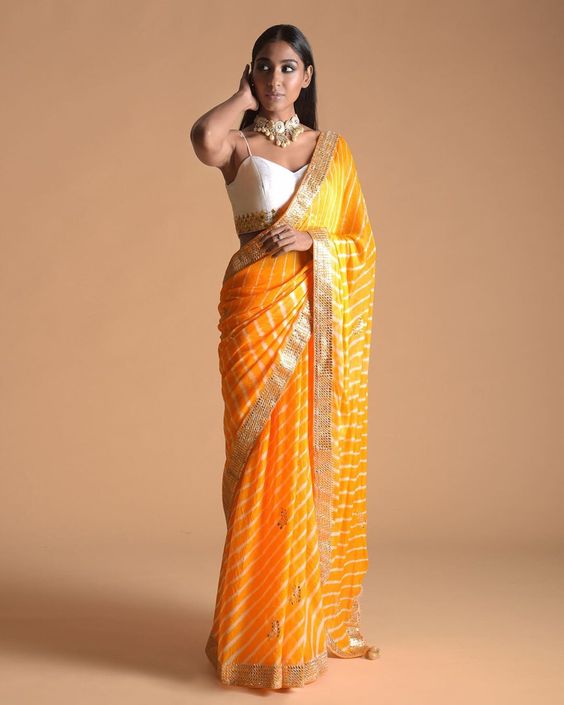 15. Simple Leheriya Saree 15. Simple Leheriya Saree - Haldi Outfit Ideas