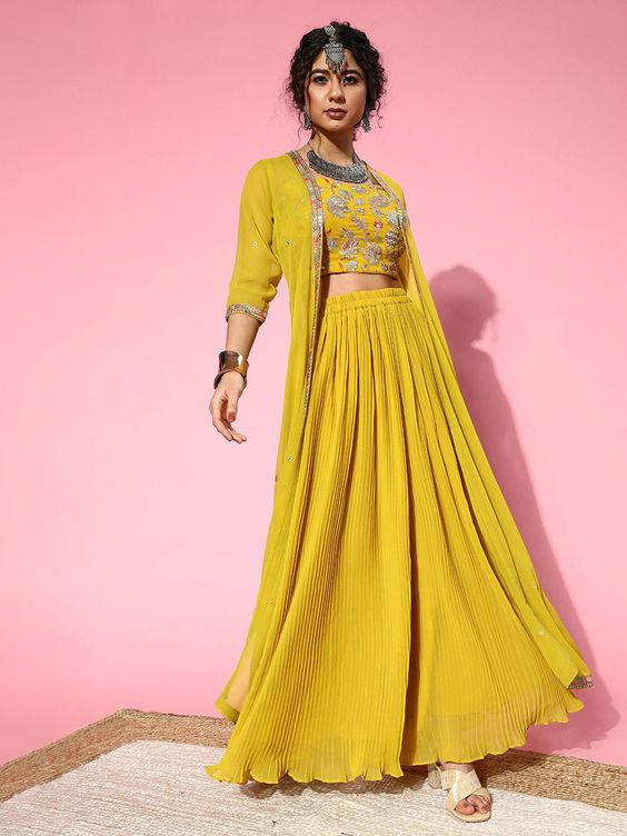 8. Pleated Skirt & Shrug 8. Pleated Skirt & Shrug - Haldi Outfit Ideas
